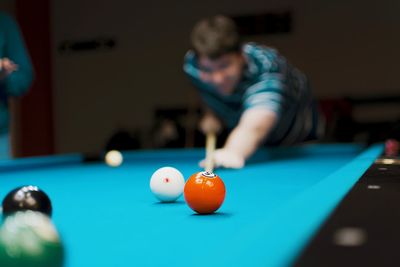 Man playing pool in darkroom