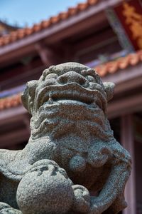 Close-up of buddha statue against building