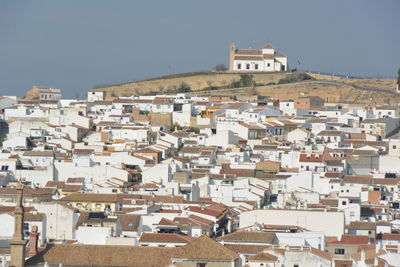 Houses in city against clear sky