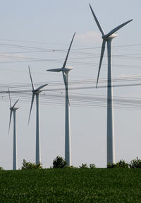 Windmill on field against sky