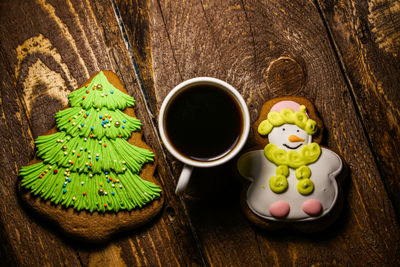 Overhead view of gingerbread cookies with coffee cup on table