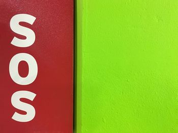 Close-up of sos sign on wall