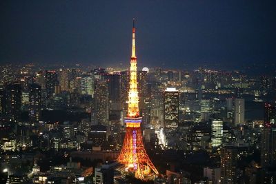 Illuminated tokyo tower in city at night