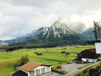 Scenic view of houses and mountains against sky