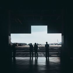Silhouette people walking in corridor of building