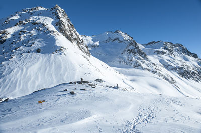 Scenic view of snowcapped mountains against clear sky