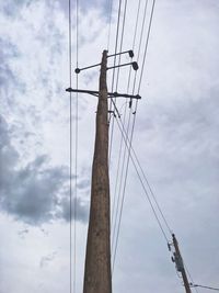 Low angle view of electricity pylon against sky