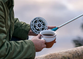 Cropped hand holding coffee