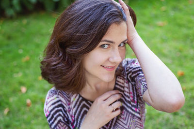 Close-up of young woman sitting on field