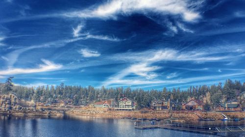 Scenic view of river against cloudy sky