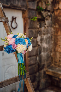 Close-up of flower vase against wall