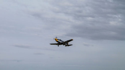 Low angle view of airplane flying in sky