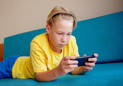 Close-up of boy using mobile phone