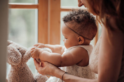 Midsection of mother and daughter at home