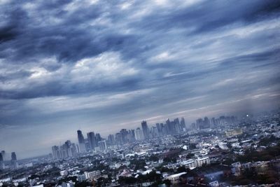 Cityscape against cloudy sky