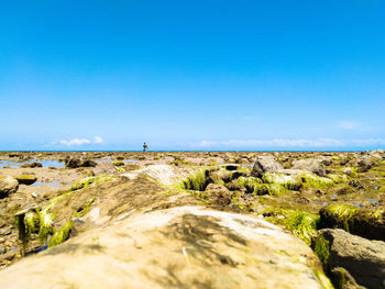 Scenic view of land against clear blue sky