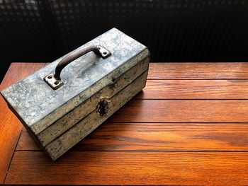 High angle view of old suitcase on wooden table