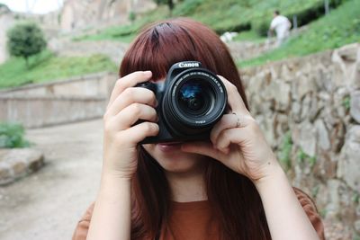 Portrait of woman photographing