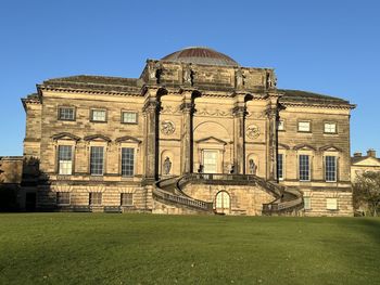 Low angle view of old ruins against clear blue sky