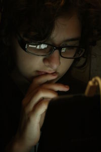 Close-up of girl using phone at home