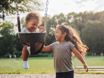 Mixed race family having fun at the kids park 
