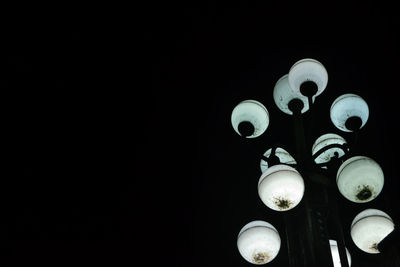 Close-up of illuminated lamp against black background