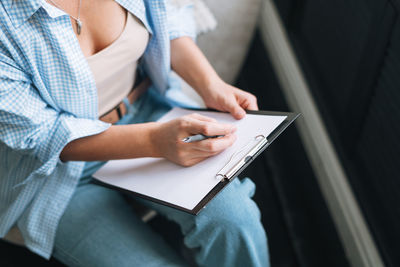 Midsection of woman using laptop