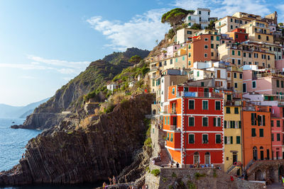 Buildings by sea against sky in city