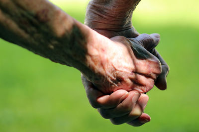 Cropped image of senior couple holding hands