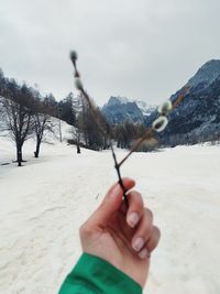 Close-up of hand holding snow