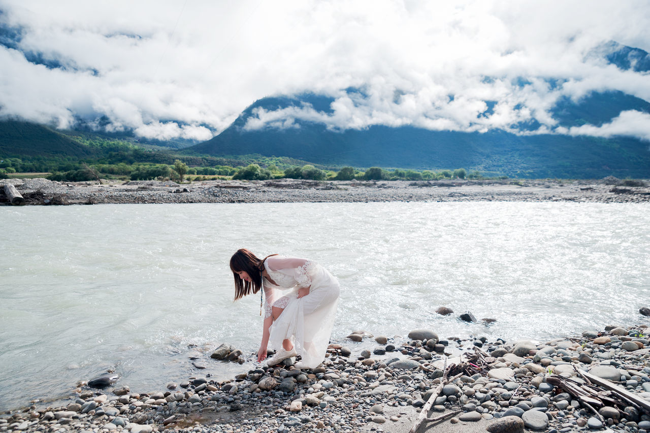 cloud - sky, water, sky, nature, one person, beauty in nature, day, mountain, one animal, sea, scenics - nature, pets, domestic, full length, land, non-urban scene, real people, outdoors