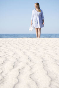 Sandy beach, woman on background