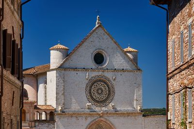 Low angle view of bell tower against blue sky