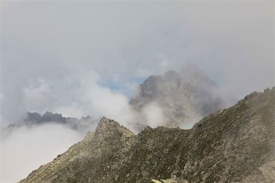 Smoke emitting from volcanic mountain against sky