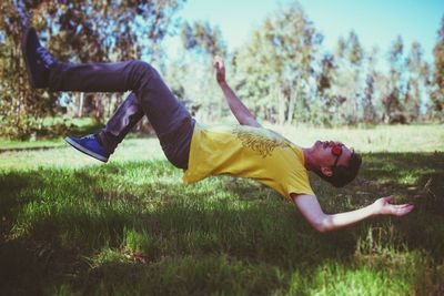 Full length side view of man falling on ground