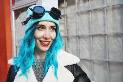 Close-up of fashionable woman with dyed blue hair in city