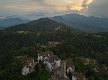 High angle view of townscape by mountain against sky