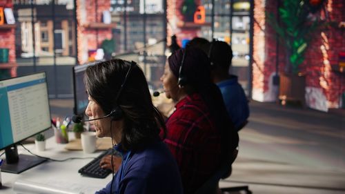 Rear view of woman using mobile phone