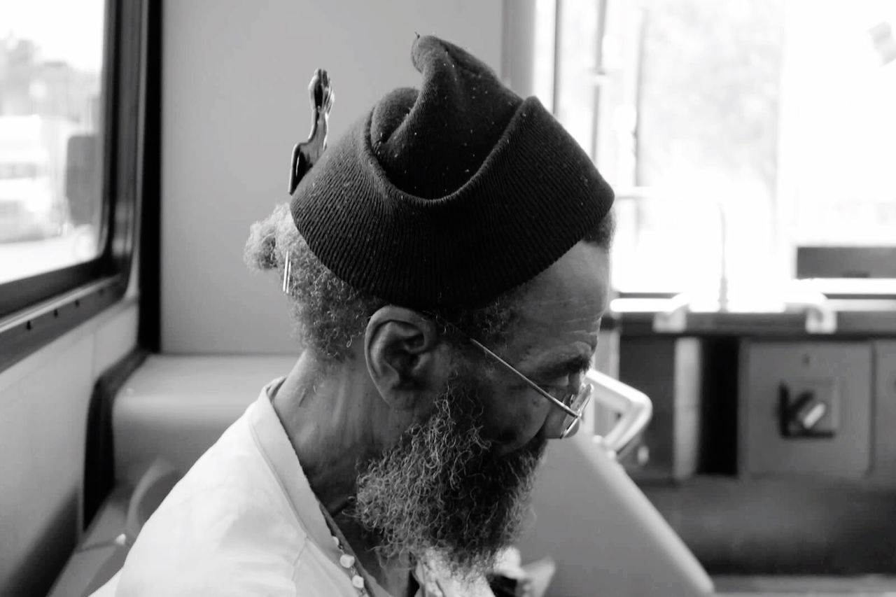 indoors, headshot, young adult, portrait, looking at camera, person, focus on foreground, front view, beard, home interior, lifestyles, head and shoulders, young men, window, close-up, mid adult, contemplation