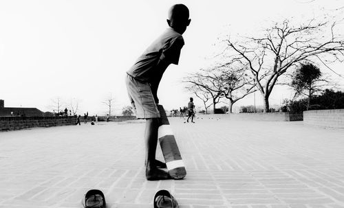 Low section of man skateboarding on snow