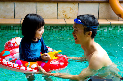 Happy family in swimming pool