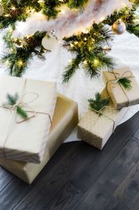 High angle view of beautifully wrapped christmas presents under tree.