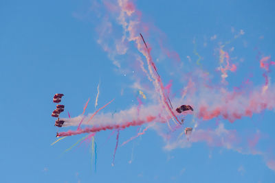 Low angle view of airshow against sky