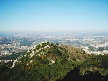 Aerial view of townscape against clear blue sky