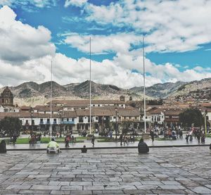 People in town square against sky