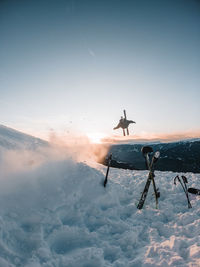 People on snowcapped mountain against sky