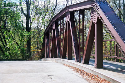 Bridge over empty road in forest