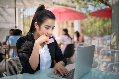 Woman using mobile phone in restaurant