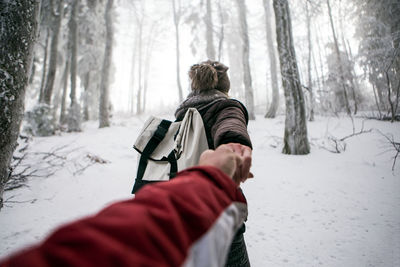 Couple in snow covered forest