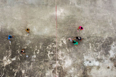 Directly above shot of children playing badminton on field